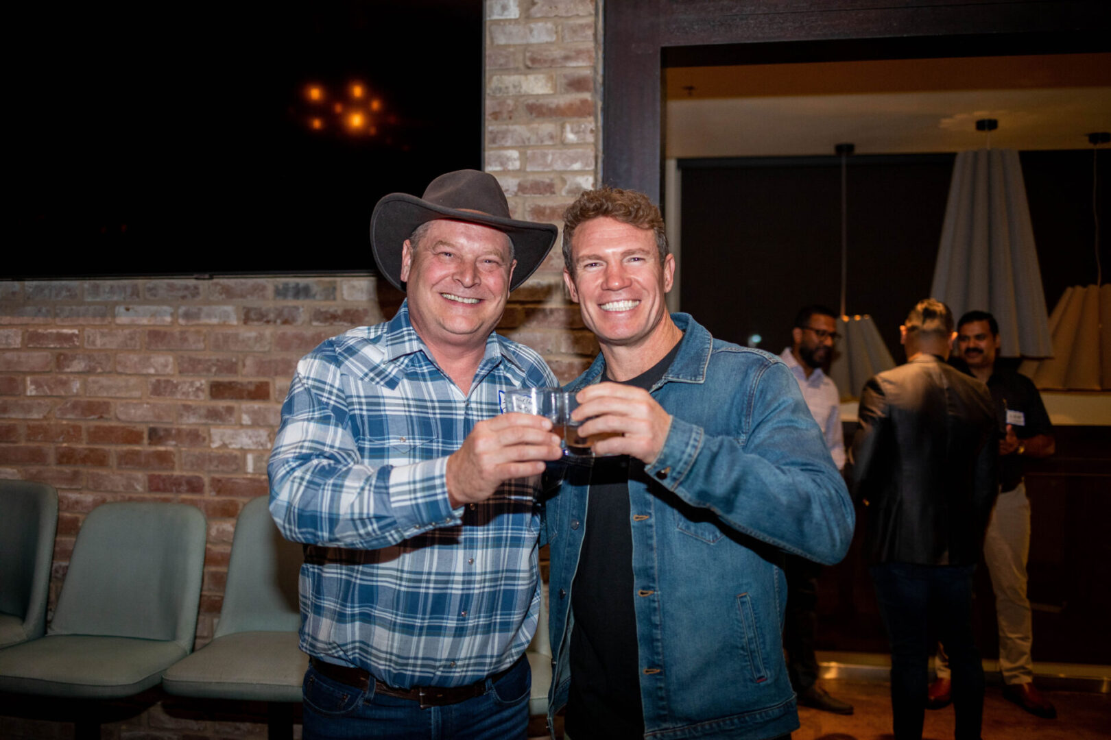 Sean and Nate Boyer holding thier drinks